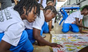 A group of girls in Mozambique make a mural with their hand prints as part of a UNICEF campaign against child marriage. Despite setbacks, some SDGs have recorded progress, such as target 5.3 on ending child marriage.