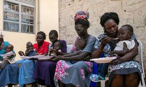Women feed their children at a nutrition site in South Sudan.