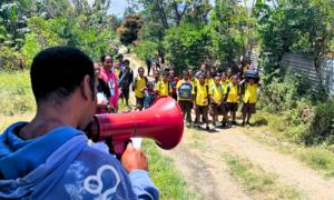 Children learn how to stay together in a visible area and shout for help during climate disasters