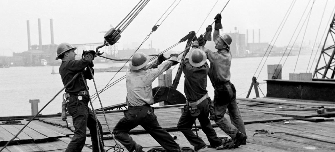 Steel workers hoist a girder in place in the meeting hall area of the UN Headquarters where construction was completed in June 1951.