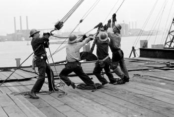 Steel workers hoist a girder in place in the meeting hall area of the UN Headquarters where construction was completed in June 1951.