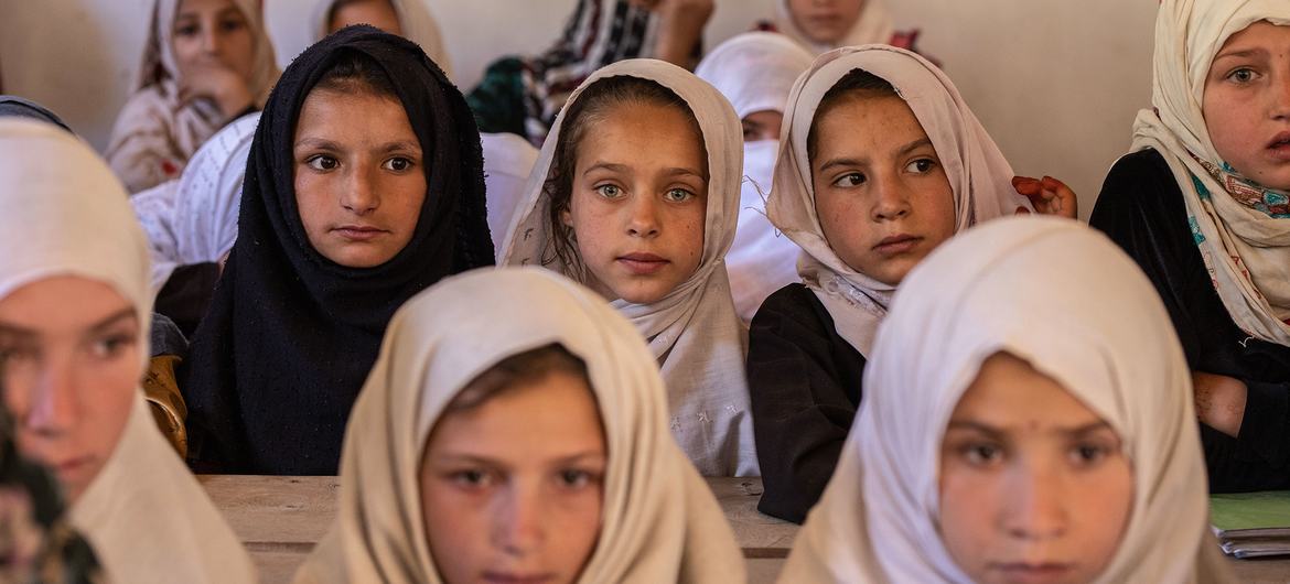 A group of elementary school girls sit in a classroom at a high school in Nuristan province, Afghanistan.
