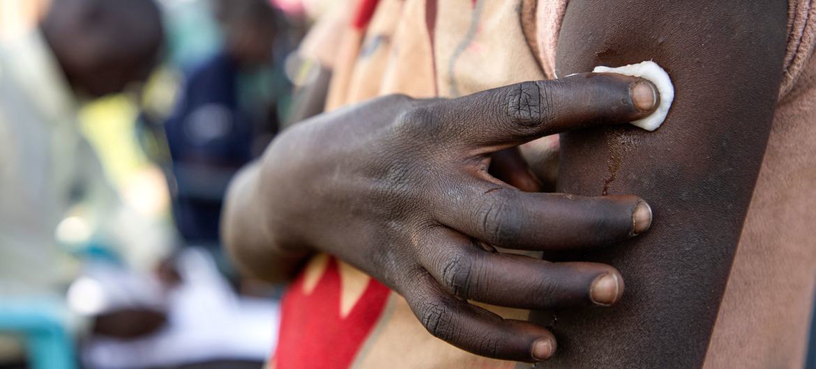 Une jeune fille tient un morceau de coton contre son bras après avoir reçu le vaccin contre le papillomavirus (HPV) dans le district de Lira, en Ouganda.