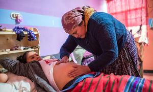 A pregnant woman in Guatemala receives care from a health worker.