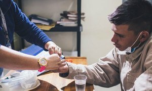 A patient receives treatment for tuberculosis in Lima, Peru.