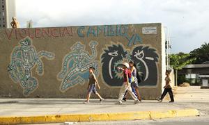 Children walk past street graffiti in Caracas, Venezuela. (file)