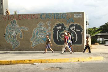 Children walk past street graffiti in Caracas, Venezuela. (file)