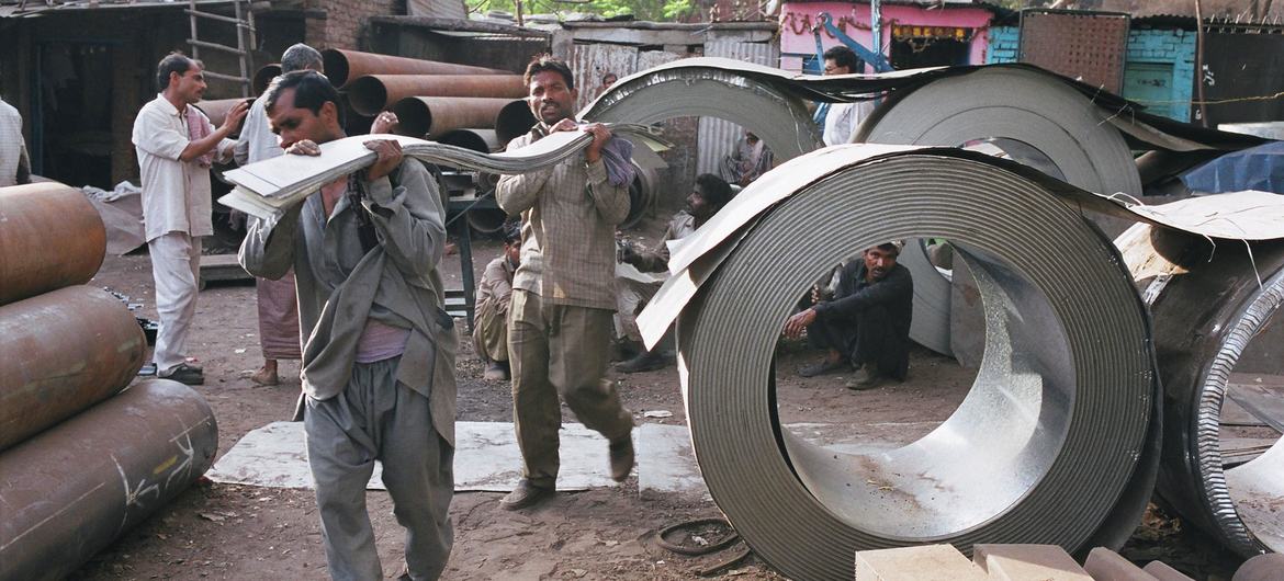 Porters work at a metal market in Narayana in New Delhi, India.