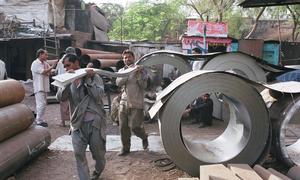 Porters work at a metal market in Narayana in New Delhi, India.