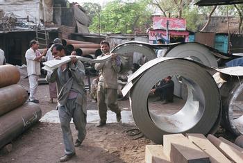 Porters work at a metal market in Narayana in New Delhi, India.