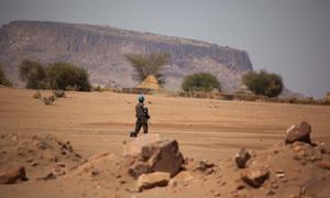 A UN peacekeeper stands guard as regional and community leaders meet for talks in Darfur. (file photo)