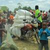 Wakimbizi wa ndani katika kambi ya Oicha nchini DRC wakipokea mgao wa chakula ktuoka kwa wafanyakazi wa WFP.