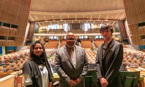 UN General Assembly President Dennis Francis (centre) welcomes New York City school students Fariha Akter (left) and Erik Ponomarev to the UN General Assembly Hall.