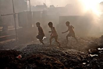 Children play in an area outside their home that has been turned into a large dumpsite of waste from leather industries in Dhaka, Bangladesh.