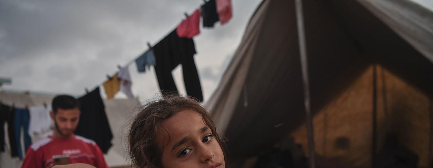 A girl rests in a camp for displaced persons in Gaza.