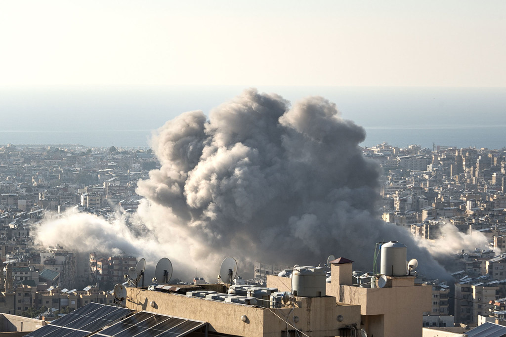 Una gran columna de humo se eleva tras un ataque con misiles en el barrio de Haret Hreik, en Beirut, Líbano, el 15 de noviembre de 2024. Al fondo se aprecian el paisaje urbano y el mar Mediterráneo.