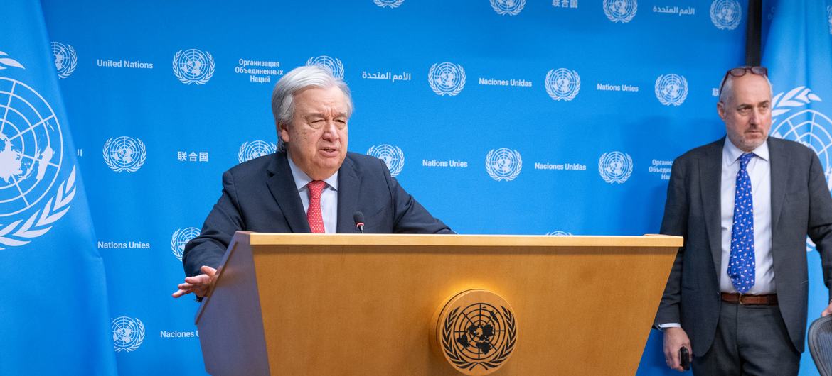 Secretary-General António Guterres (at podium) briefs reporters on the situation in Gaza. At right is Stéphane Dujarric, Spokesperson for the Secretary-General.