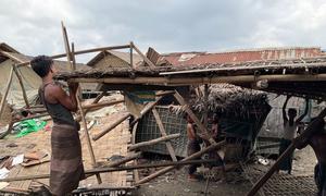 Men repair a shelter damaged by Cyclone Mocha in Nget Chaung 2 IDP camp in Rakhine state in Myanmar.