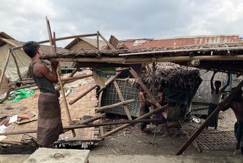 Men repair a shelter damaged by Cyclone Mocha in Nget Chaung 2 IDP camp in Rakhine state in Myanmar.