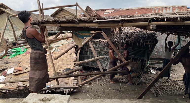 Men repair a shelter damaged by Cyclone Mocha in Nget Chaung 2 IDP camp in Rakhine state in Myanmar.
