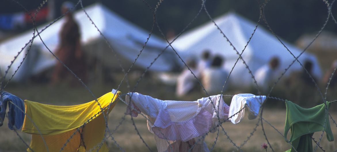 Barbed wire around a camp for some 25,000 people displaced from Srebrenica. The fence was there to keep people from wandering into the surrounding fields that may have been mined. (1995 photo)