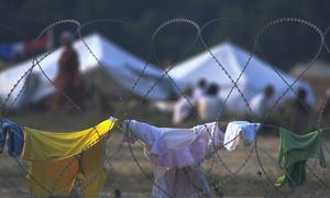 Barbed wire around a camp for some 25,000 people displaced from Srebrenica. The fence was there to keep people from wandering into the surrounding fields that may have been mined. (1995 photo)