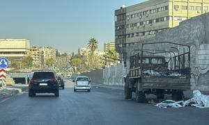 Abandoned military vehicles lie idle on a highway, reflecting remnants of past conflict in Damascus, Syria, on 14 December 2024.