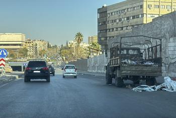 Abandoned military vehicles lie idle on a highway, reflecting remnants of past conflict in Damascus, Syria, on 14 December 2024.