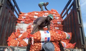 Men unload sacks of onions from a truck in Bamako, Mali, a landlocked developing country. Their lack of direct access to the vital trade links often result in landlocked countries paying high transport and transit costs.