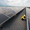 A technician works at a solar panel plant in Thailand.