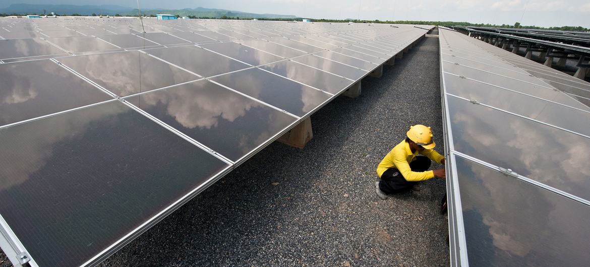A technician works at a solar panel plant in Thailand.