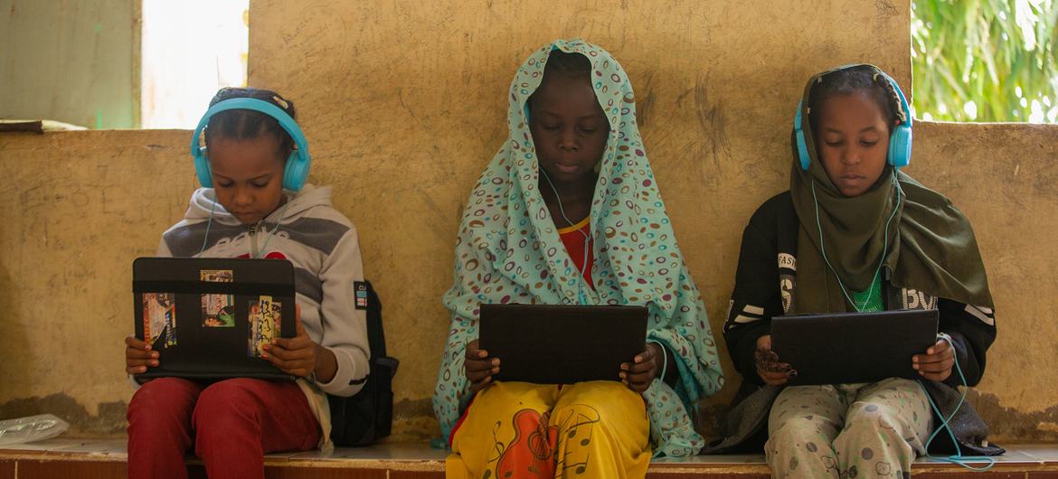 Girls who fled their homes in war-torn Sudan take part in a digital learning session in Kassala state. Girls who fled their homes in war-torn Sudan take part in a digital learning session in Kassala state.