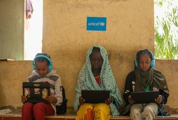 Girls who fled their homes in Sudan participate in a digital learning session in Kassala state.