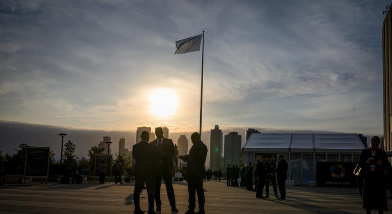 Delegates gather on the plaza in front of the General Assembly building at UN Headquarters.