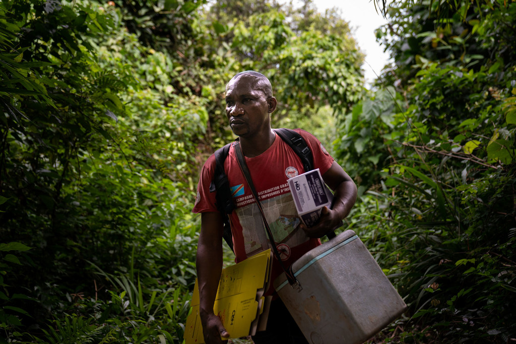 A nurse delivers vaccines to remote villages on the banks of the Congo River in the Democratic Republic of Congo. 