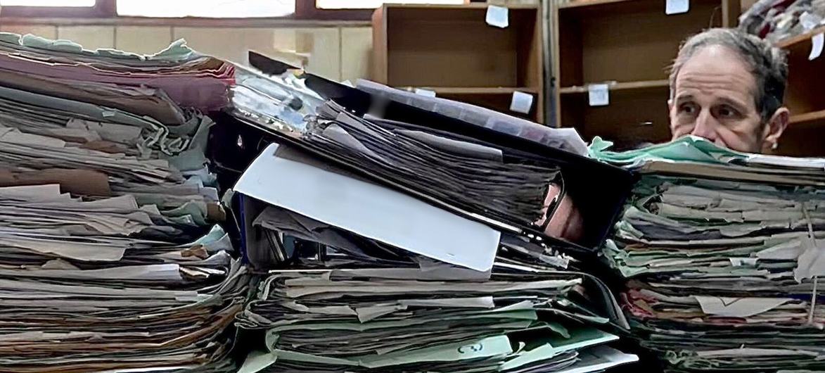 The head of the International, Impartial and Independent Mechanism Investigating Serious Crimes in Syria (IIIM), Robert Petit, looks at documents at a court house in Damascus, Syria.
