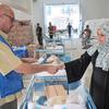 A Palestine refugee receives food assistance packages at the UNRWA Jabalia distribution centre in Gaza.