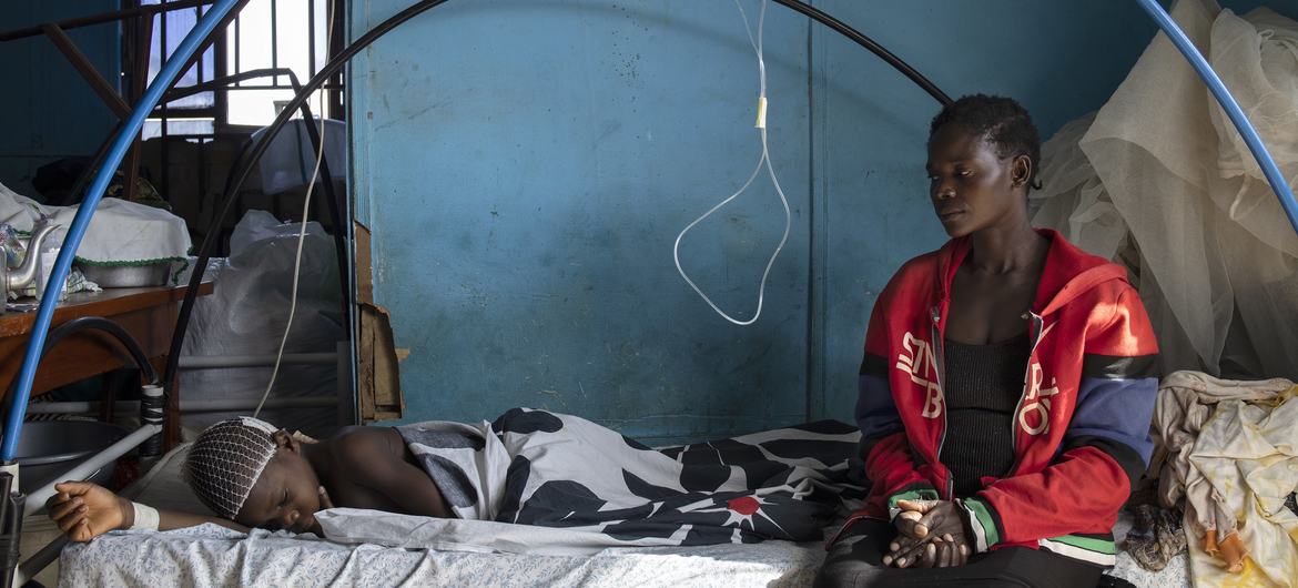 A 14-year-old teenage boy rests at the hospital under the watch of his aunt. The family was attacked by armed men in March 2022 in their village, in the surroundings of Bunia.