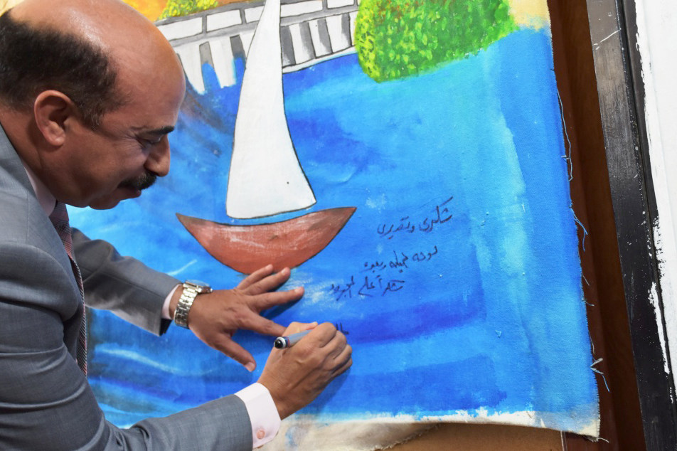 قام اللواء أشرف عطية بتوقيع رسمة رسمها طفل لمركب شراعي خلال احتفال باليوم العالمي للمياه في مصر.