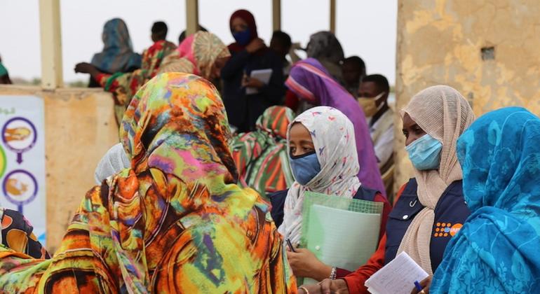 Members of a UNFPA-supported community network in Sudan speak to women in about the dangers of female genital mutilation.
