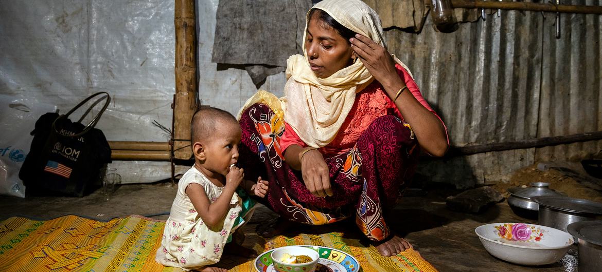 A two-year-old girl suffering from malnutrition is fed by her mother at their shelter in Cox's Bazar, Bangladesh. A two-year-old girl suffering from malnutrition is fed by her mother at their shelter in Cox's Bazar, Bangladesh.