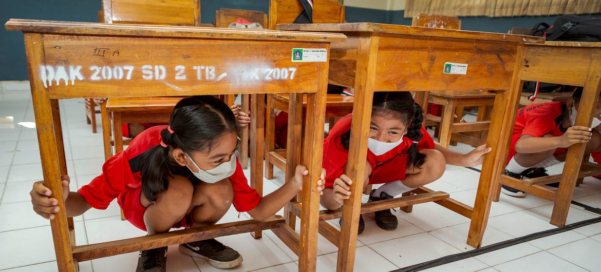 to Children in Indonesia practice tsumani preparedness drills at school.