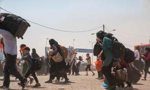 Afghans return home from Iran through the Islam Qala border crossing.