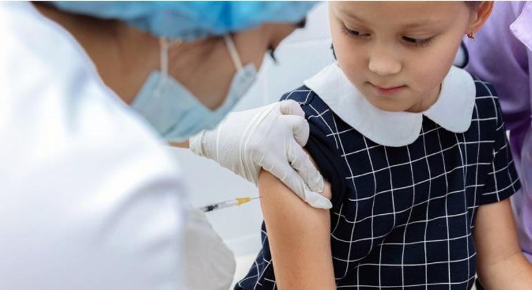 A girl in Kazakhstan receives a measles vaccine. New trials of a vaccine patch instead of shots, are showing promise. 