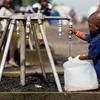 A child fills a jerrycan with safe water at a displaced camp near Goma, in the Democratic Republic of the Congo.