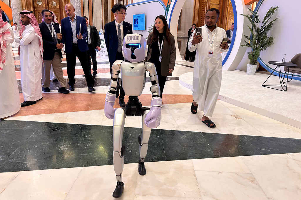 An AI-enabled humanoid robot walks the corridors of the 2025 UNIDO Global Industry Summit in Riyadh, Saudi Arabia. An AI-enabled humanoid robot walks the corridors of the 2025 UNIDO Global Industry Summit in Riyadh, Saudi Arabia.