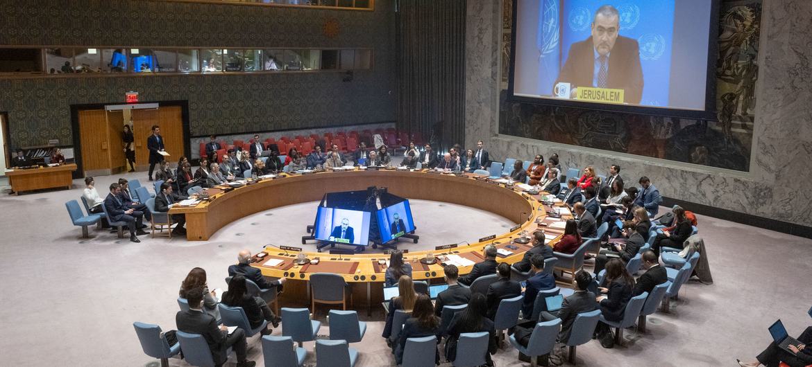 A wide view of the UN Security Council meeting on the Middle East on Monday 24 November. Ramiz Alakbarov (on screen), Deputy Special Coordinator for the Middle East Peace Process, briefed ambassadors.