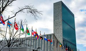 The Secretariat building with flags of Member States in the foreground, at UN Headquarters, in New York.