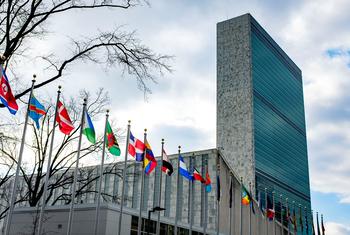 The Secretariat building with flags of Member States in the foreground, at the UN Headquarters, in New York.