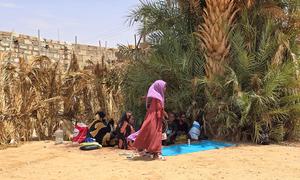 A Sudanese refugee, recently arrived in Libya, walks in Alkufra, the main entry point to the country.